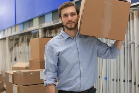 Portrait of a smiling warehouse keeper at work. Stock Photos