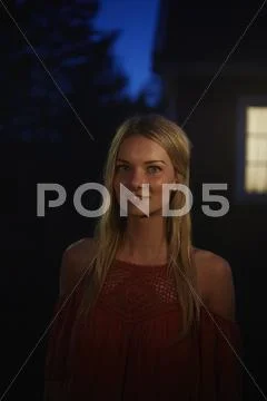 Portrait smiling woman in dark backyard Stock Photos