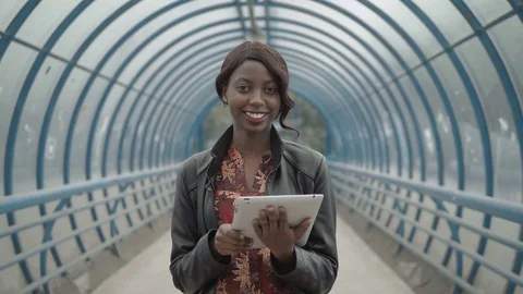 Portrait of smiling woman in office with tablet, black american student on city Stock Footage
