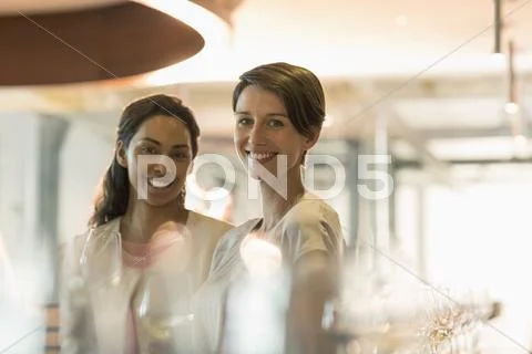 Portrait smiling women wine tasting in winery tasting room Stock Photos