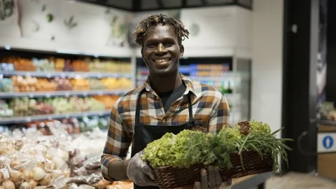 Portrait smiling worker at the store with basket full of greens Vídeos de archivo 151320995