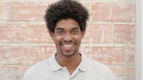 Portrait of a smiling young afro man looking at camera Stock Footage 155987376
