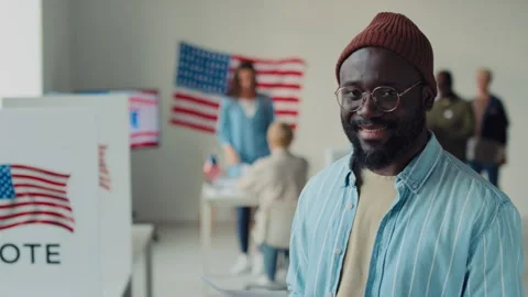 Portrait of Smiling Young Black Man at Polling Station on US Election Day Stock Footage 244820602