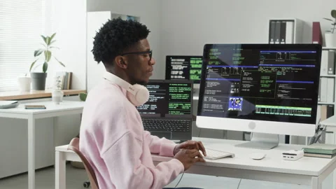 Portrait of Smiling Young Black Programmer Sitting at Workstation in Office Stock Footage 330124938