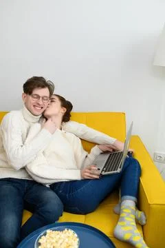 Portrait of a smiling young couple using laptop at home indoor Stock Photos