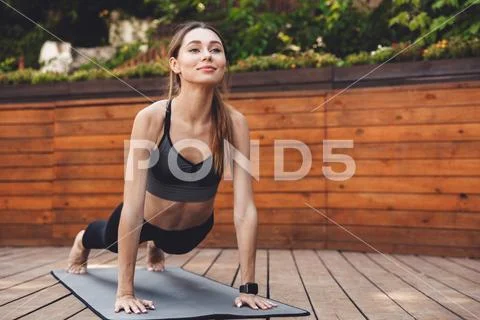 Portrait of a smiling young fitness girl Stock Photos