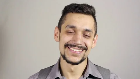 Portrait of a smiling young man with a beard Stockbeeldmateriaal 75380866