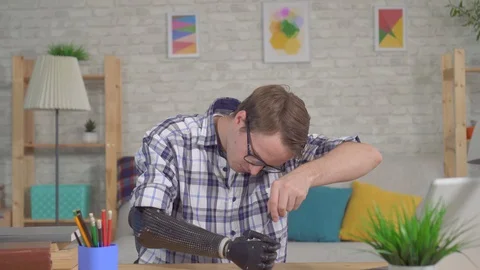 Portrait smiling young man with a bionic prosthetic hand gives a thumbs up Stock Footage 119780648