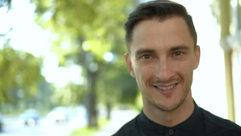 Portrait of smiling young man Cute caucasian brunette guy looking at camera Video stock 104596893