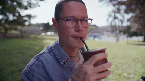 Portrait of Smiling Young Man Drinking Yerba Mate Tea in Park Stock Footage 345388766