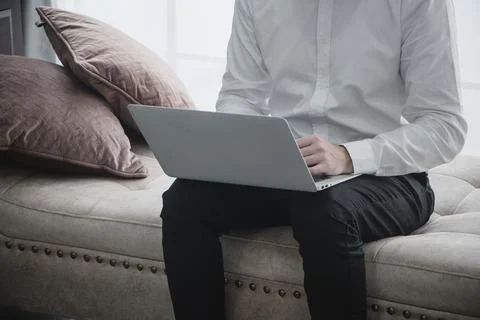 Portrait of smiling young man using laptop computer Stock Photos