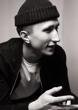 Portrait of smiling young  man  wearing black knit hat. Black and white studi Stock Photos