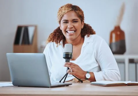 Portrait of smiling young mixed race female presenter using a mic and wireless Stock Photos