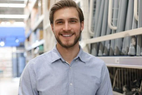 Portrait of a smiling young warehouse worker working in a cash and carry Stock Photos