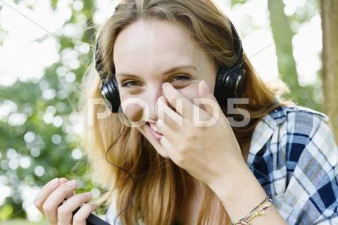 Portrait Of A Smiling Young Woman With Headphones