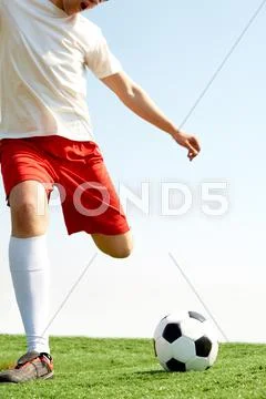 Portrait of a soccer player with ball on football field Stock Photos
