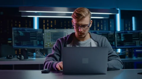 Portrait of Software Developer / Hacker / Gamer Wearing Glasses and Headset Sit Stock Footage 103576552