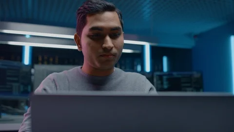 Portrait of Software Developer / Hacker / Programmer Sitting at His Desk Stock Footage 103578215