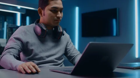 Portrait of Software Developer / Hacker / Programmer Sitting at His Desk Stock Footage 103578568
