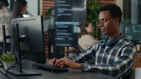 Portrait of software engineer writing code arranging glasses and being happy Stock Footage 168253350