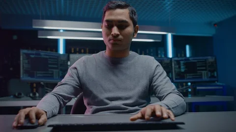 Portrait of Software Programmer Sitting at His Desk and Working on Computer Stock Footage 103578139