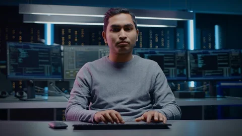 Portrait of Software Programmers Sitting at His Desk and Working on PC Stock Footage 103577794