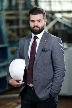 Portrait of a solid businessman controlling work process in a airplane factory. Stock Photos