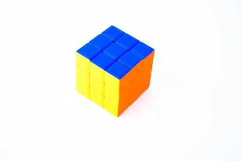 Portrait of a solved rubik cube in an isolated white background displaying bl Stock Photos