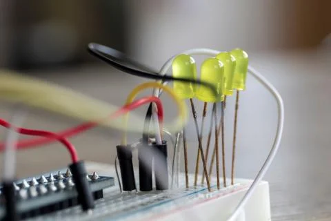 A portrait of a some electronics, it is a bread board with some LED's attache Stock Photos