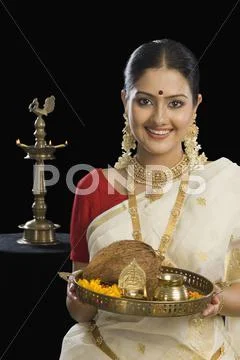 Portrait of a South Indian woman holding a plate of religious offerings Stock Photos