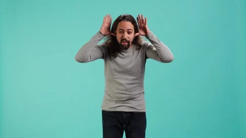 Portrait of spiteful man making exaggerated silly faces, mimicking someone Stock Footage 323536992