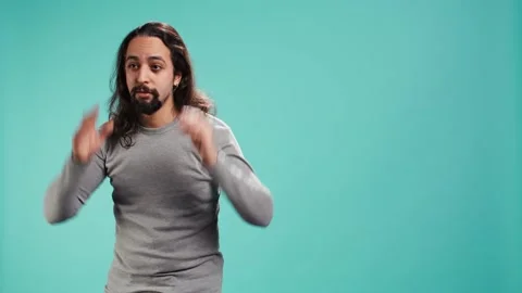 Portrait of spiteful man making exaggerated silly faces, mimicking someone Stock Footage 323537481