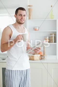 Portrait of a sports man drinking coffee while reading the news Stock Photos