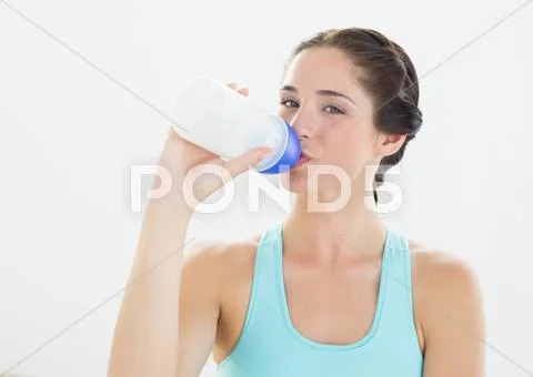 Portrait of a sporty woman drinking water Stock Photos