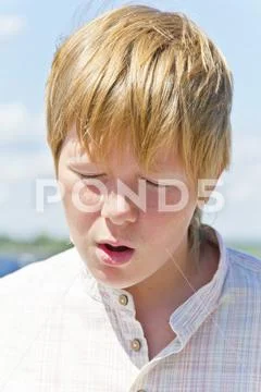 Portrait of squint blond boy near river Stock Photos