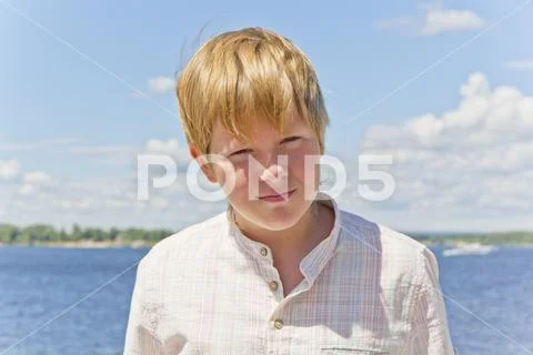 Portrait of squint blond boy near river Stock Photos