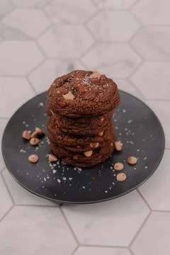Portrait of a stack of peanut butter cookies on black plate Stock Photos