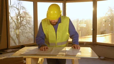 PORTRAIT: Static technician smiles after analysing the floor plans at sunrise. Stock Footage 125047394