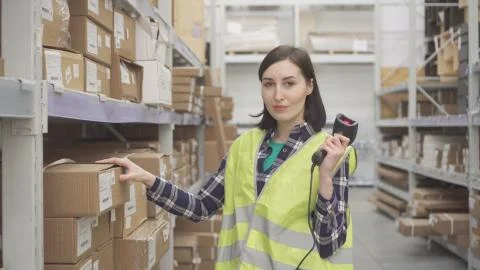 Portrait store worker using bar code scanner scanning labels on boxes Stock-Fotos