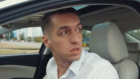 Portrait of stressed man driver is drinking an alcoholic drink while sitting in Stock-Footage 131036131