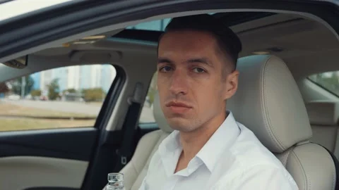 Portrait of stressed man driver is drinking an alcoholic drink while sitting in Stock-Footage 131117080