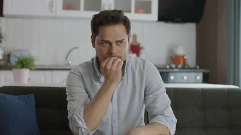 Portrait of stressed man sitting on sofa at home in living room. Stock Footage 188827663