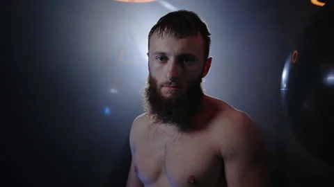 Portrait of the strong athletic boxer is sweating after hard training standing Stock Footage 209302277