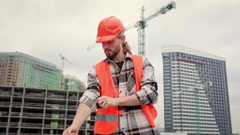 Portrait of strong builder outside, construction site Stock Photos