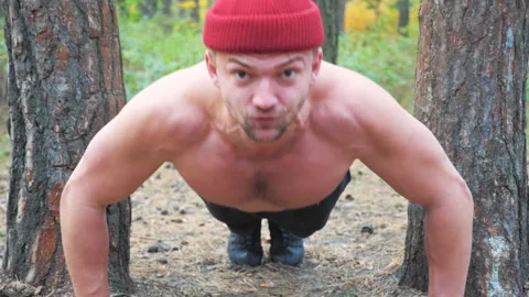 Portrait of strong man doing push ups with crazy expression on face. Sportsman Stock Footage 300085408