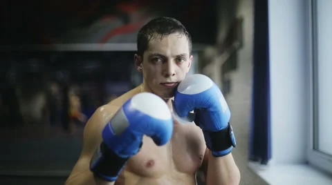 Portrait of strong man kickboxer doing self-defense and looking at camera Stock Footage 60571789