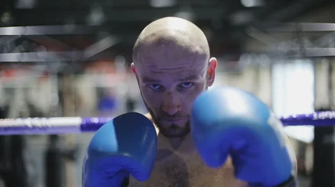 Portrait of strong man kickboxer doing self-defense and looking at camera Stock Footage 60574610