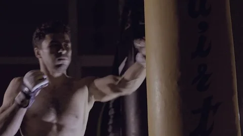 Portrait of strong man training punching bag. Stock-Footage 76915695