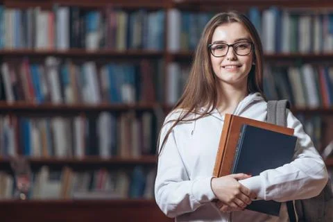 Portrait of student holding books at library Stock-Fotos