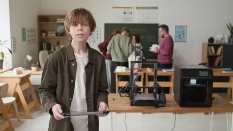 Portrait of Student Holding Tablet During Group 3D Modeling Class in School Stock Footage 335695698